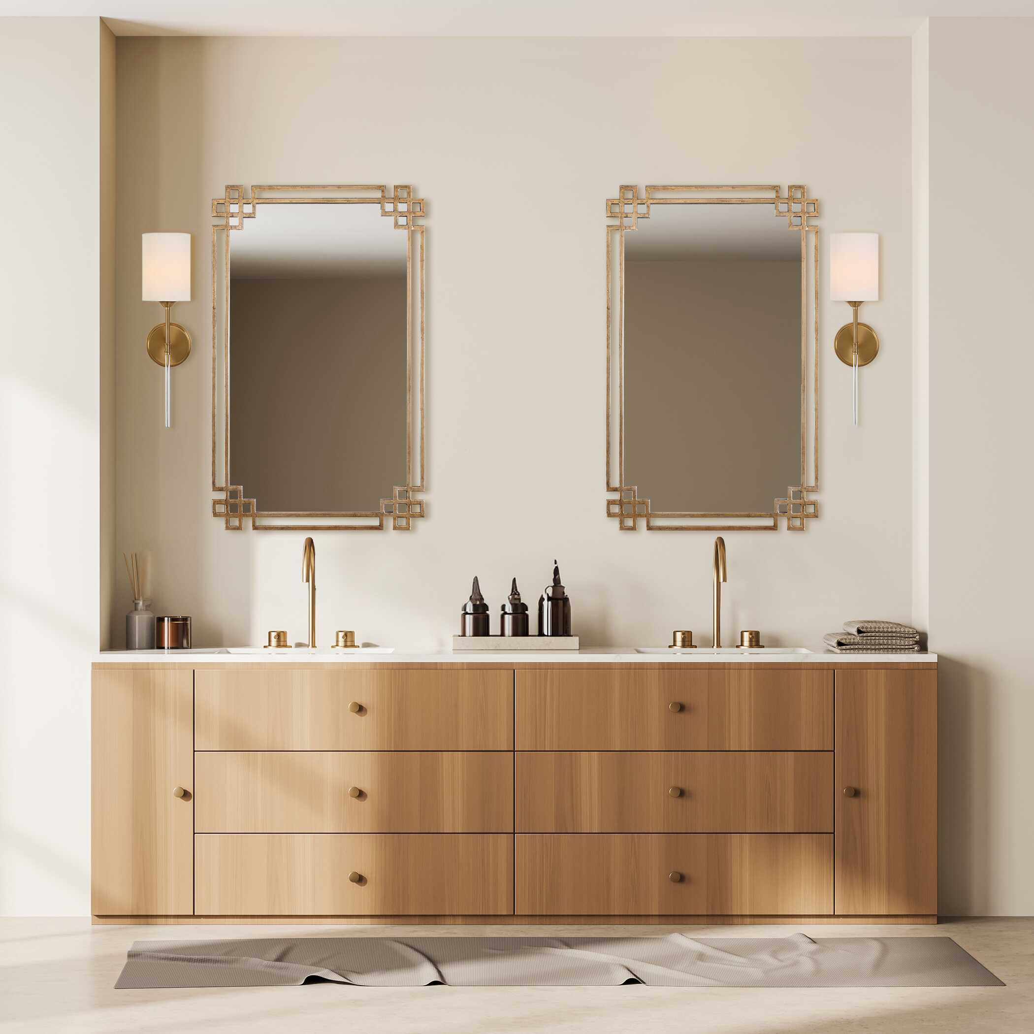 Modern brass wall sconce featuring a white fabric shade and warm brass finish
