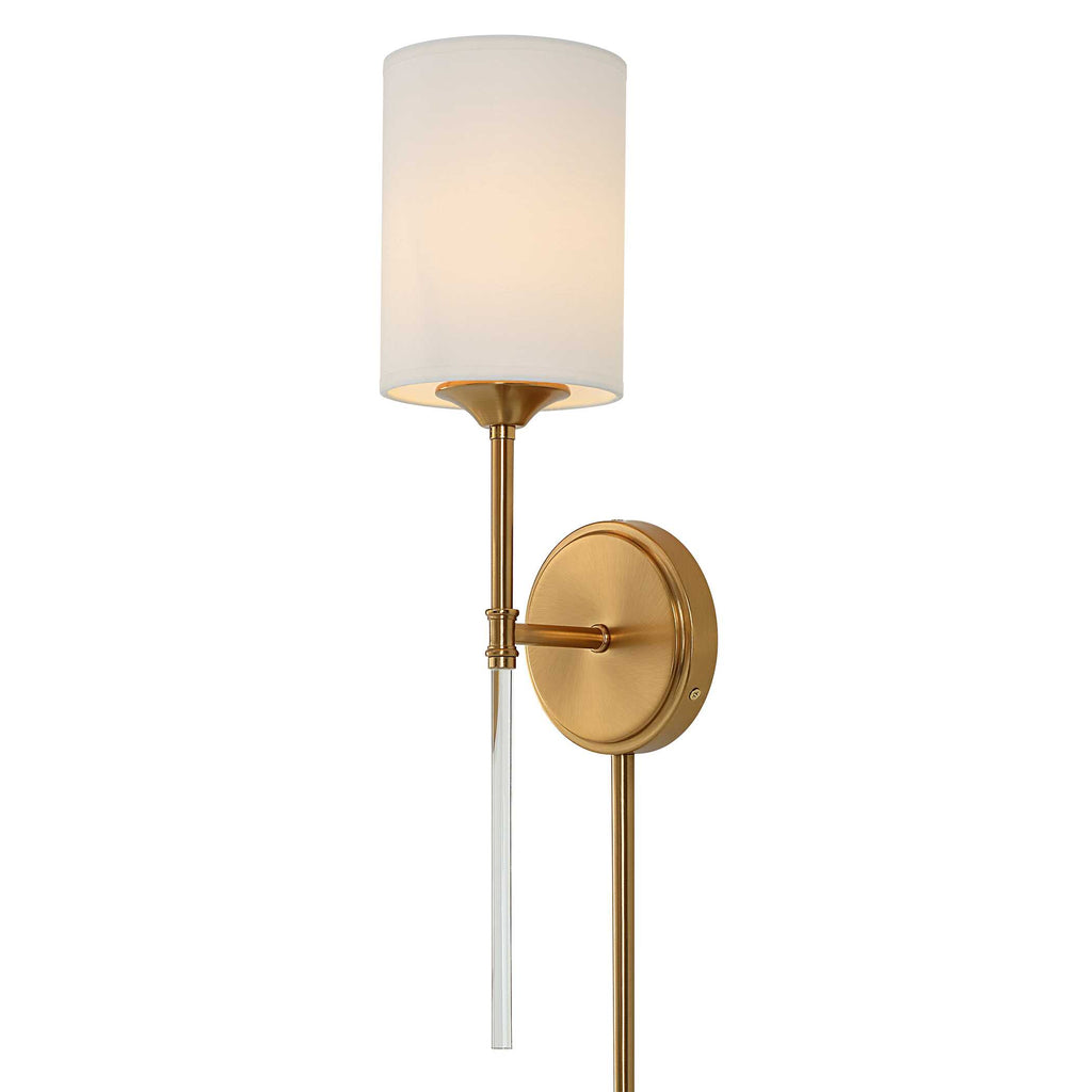 Awyr modern brass wall sconce installed beside a bedroom headboard