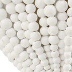 White beaded wall sconce with handcrafted wood beads