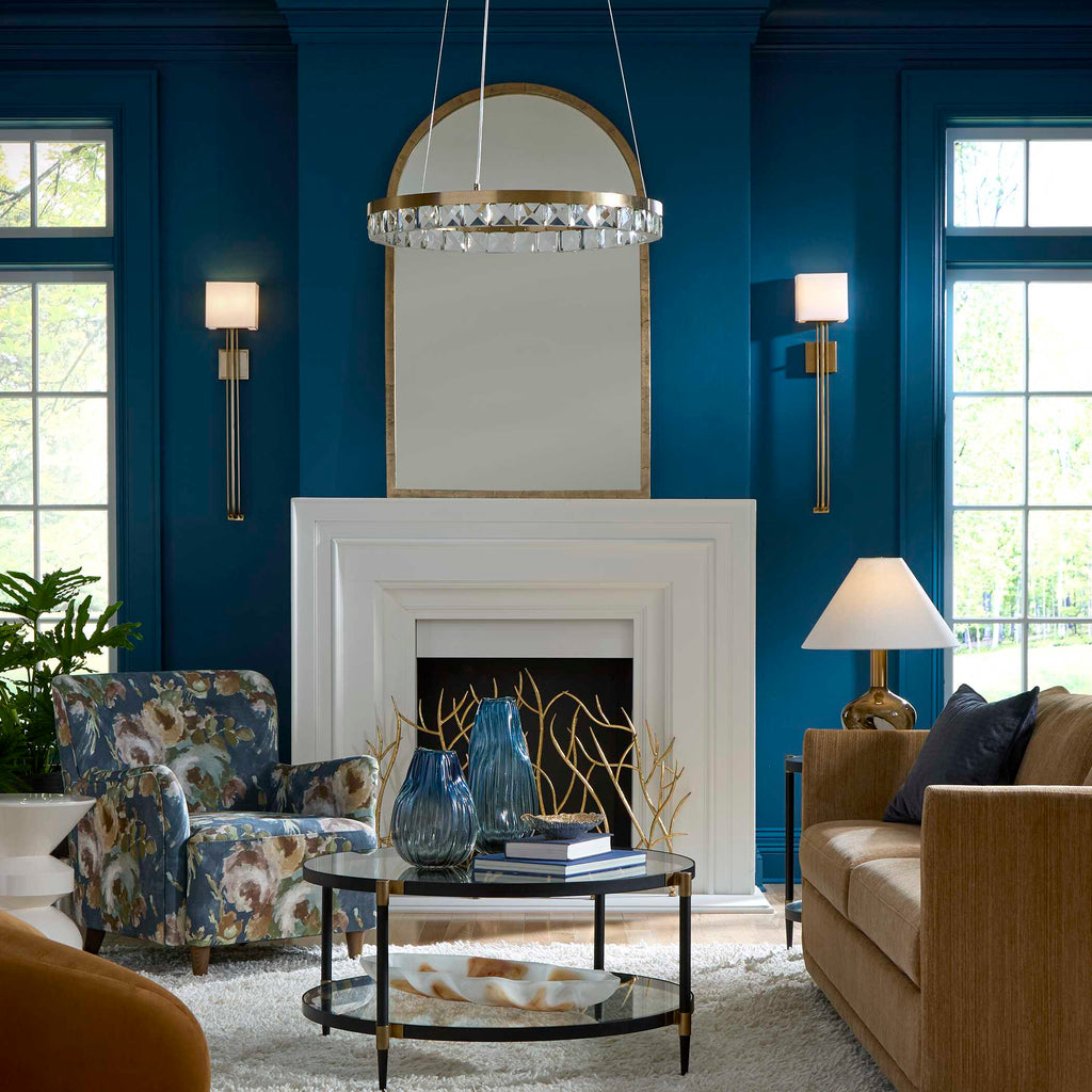 Warm brass wall sconce adding ambient lighting to a hallway