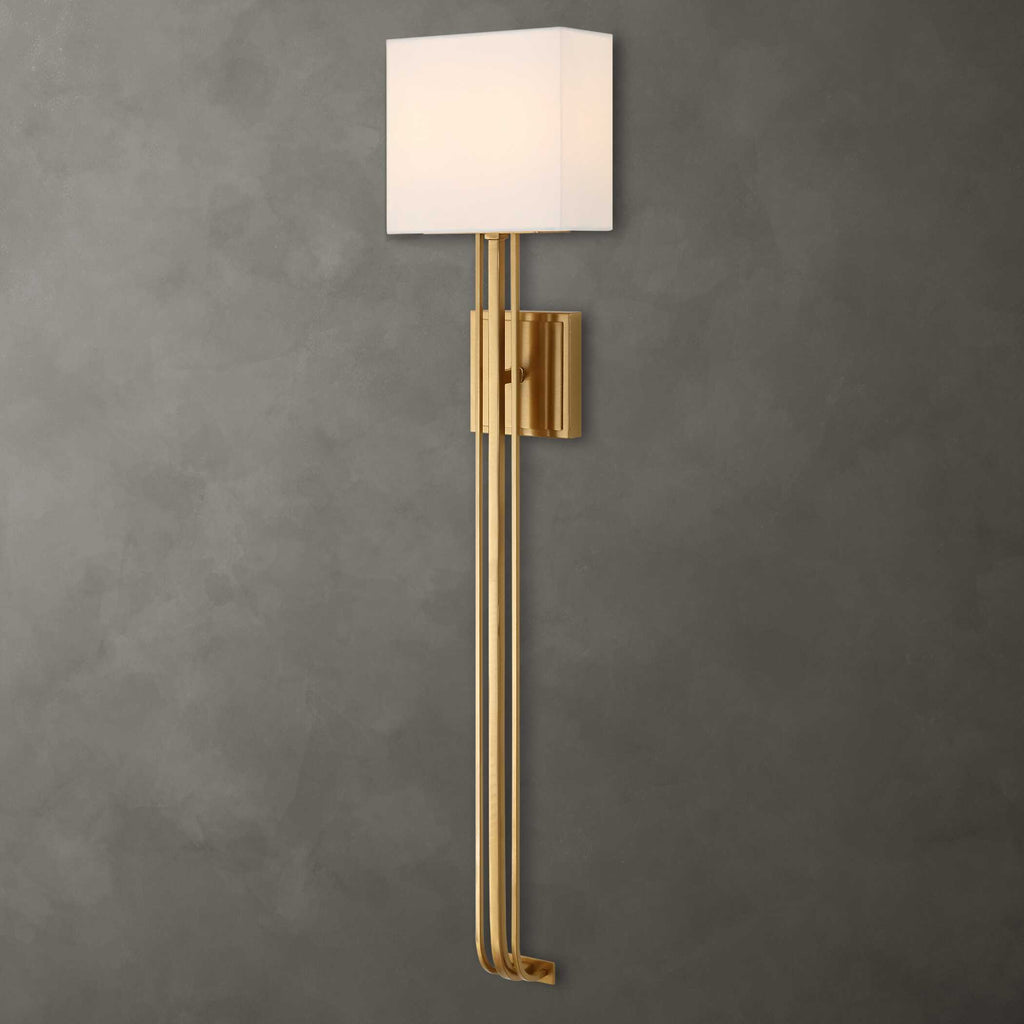 Side view of Trenton modern brass wall sconce with white fabric shade