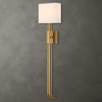 Side view of Trenton modern brass wall sconce with white fabric shade